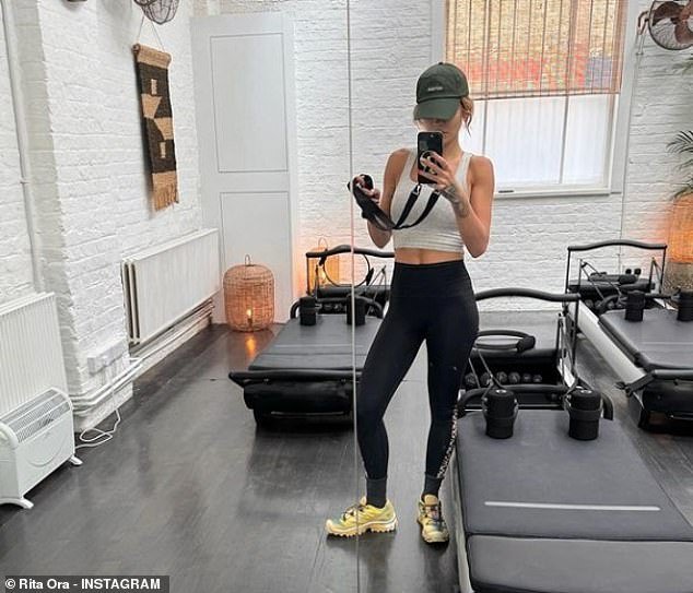 Rita also shared another photo as she prepared for a reformer pilates workout as she showed off her abs in a gray tank top and black gym leggings