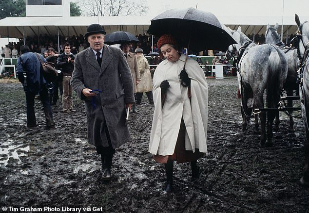 The Queen wades through the mud to present prizes at the Windsor Horse Show
