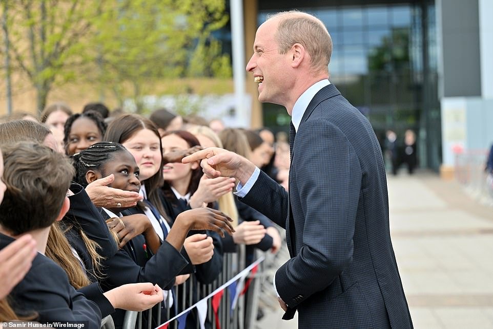 Prince William, Prince of Wales, was all smiles as he was greeted by schoolchildren during his visit to St Michael's Church of England School in Birmingham yesterday.  He seemed very happy, perhaps after hearing the good news about his father