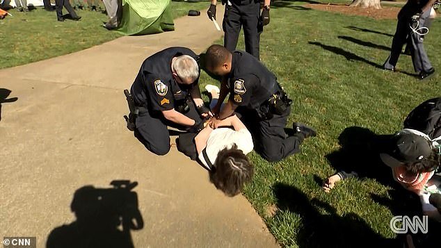 Economics teacher Caroline Fohlin was wrestled to the concrete by an officer after she tried to intervene during the arrest of another protester