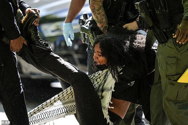Encampments have sprung up at universities across the country as pro-Palestinian students demand that their institutions be divested from companies linked to Israel.  Pictured: A protester detained at Emory on April 26