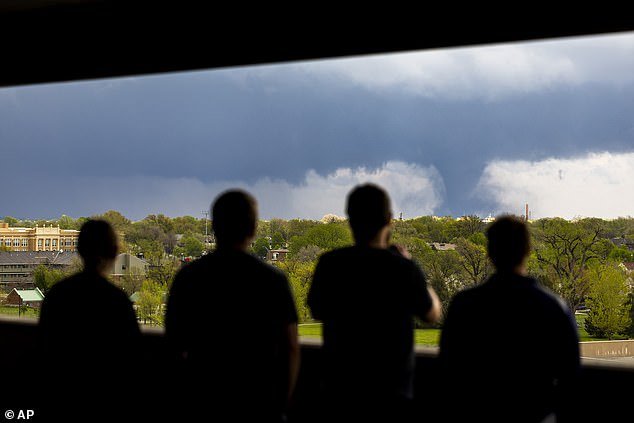 Ally Mercer, Gabe Sedlacek Kaleb Andersen and Austin Young watch a tornado from a seventh-floor parking garage in Lincoln, Nebraska on Friday