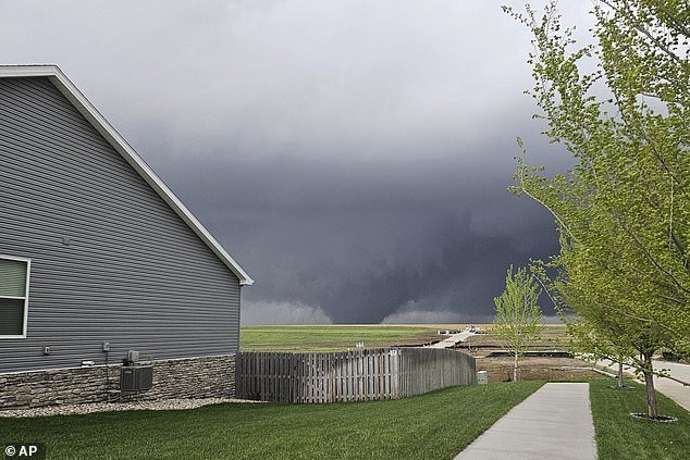 A tornado moves through the suburbs northwest of Omaha on Friday, as seen from Bennington, Nebraska