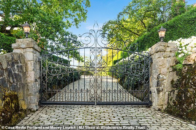 Beyond the gate entrance, a cobblestone driveway provides an impressive entrance