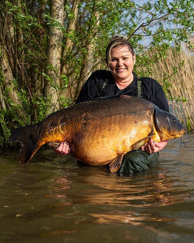 The huge fish is known as Pashley and is the largest in the lake - it is also the largest caught by a woman in Britain