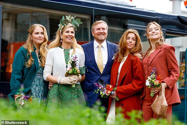 Queen Máxima of the Netherlands was typically chic in an olive green dress and striking headpiece as she and her family attended King's Day celebrations today