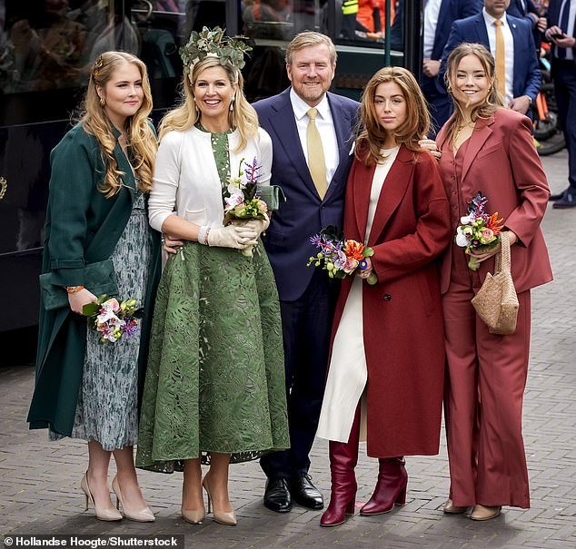 She combined her outfit with a striking headdress of green butterflies and completed her King's Day ensemble with a cream-colored cardigan, matching gloves and simple heels.