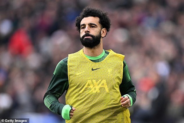 Salah cut a sullen figure during the pre-match warm-up and as he prepared to come on