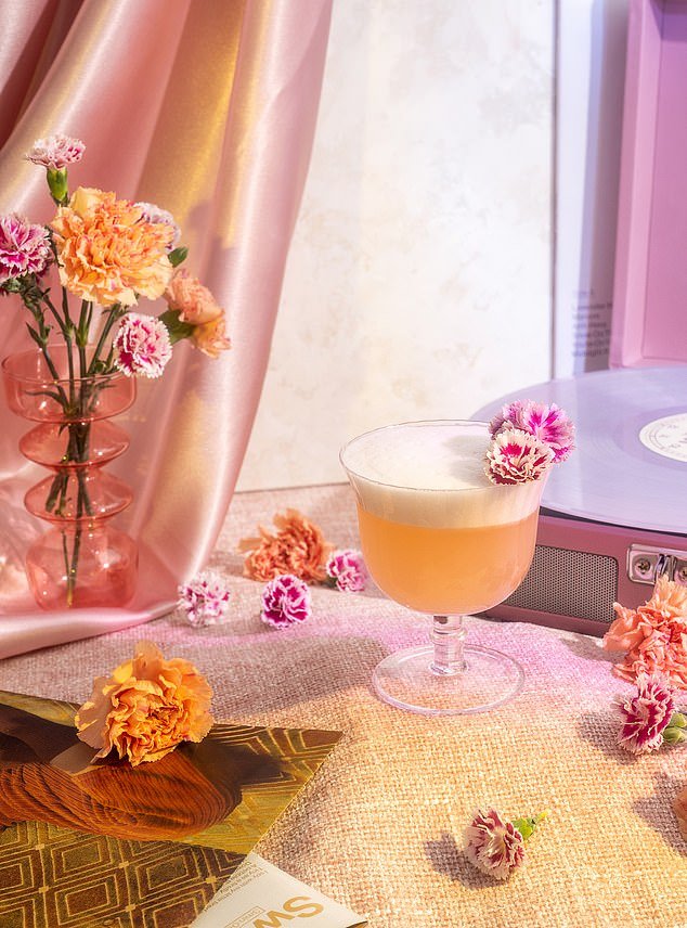 Pictured: A Grapefruit Gin Fizz cocktail inspired by Taylor Swift's song 'Sweet Nothing' from her Midnights Album
