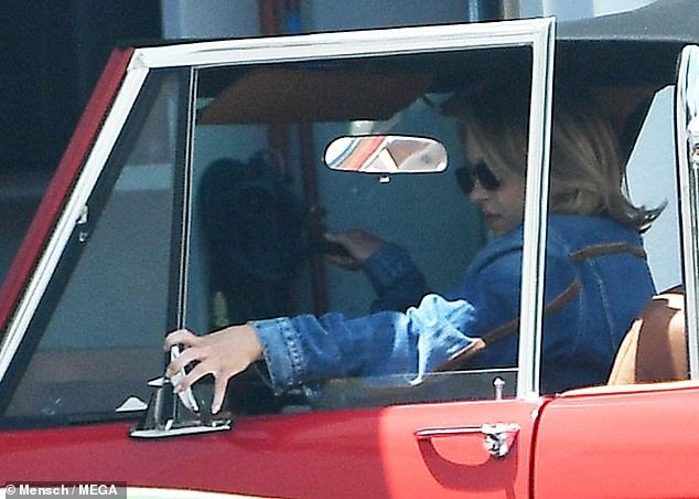 The Everyone But You star, 26, looked jubilant as she drove the cherry red vintage vehicle