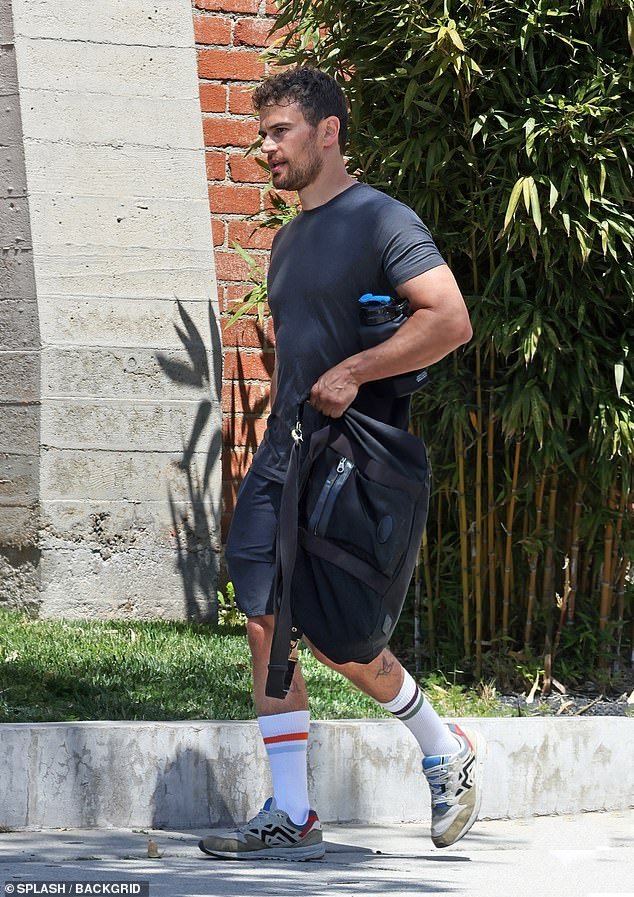 The Gentlemen star, 39, showed off his gym-honed physique as he wore a gray T-shirt and matching shorts for the outing