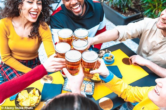 Friends enjoy a beer.  Over the past week, a flood of disturbing research has been published about the damage caused by alcohol - with even just one glass of wine a day putting us at greater risk of cancer and liver damage (stock image)