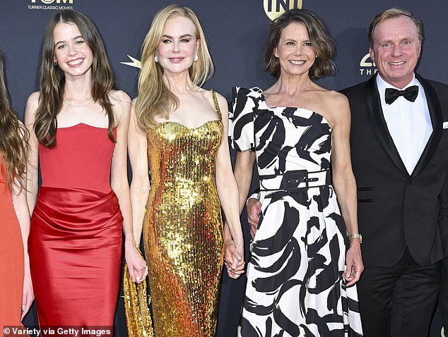 Faith and Sunday glowed with childish pride as they stood next to their mother, who was dressed in a glittering gold Balenciaga dress