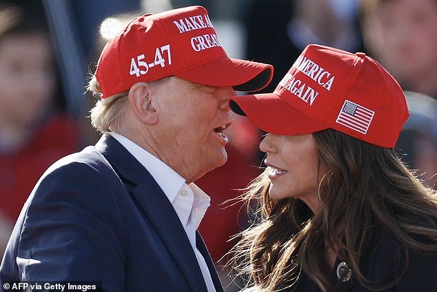 Republican presidential candidate Donald Trump speaks with North Dakota Governor Kristi Noem during a Buckeye Values ​​PAC Rally in Vandalia, Ohio, on March 16, 2024