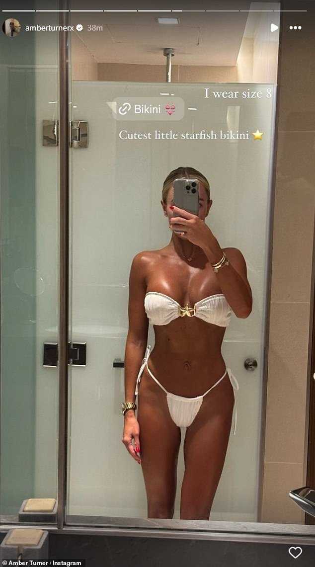 She posted a photo of another bikini, swapping blue for a white strapless one as she showed off her glowing tan