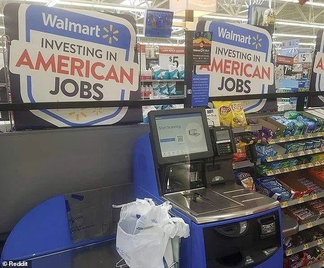 A photo of the 'scan and go' self-checkout machines at Walmart, ironically placed next to a poster claiming the company is 'investing in American jobs'
