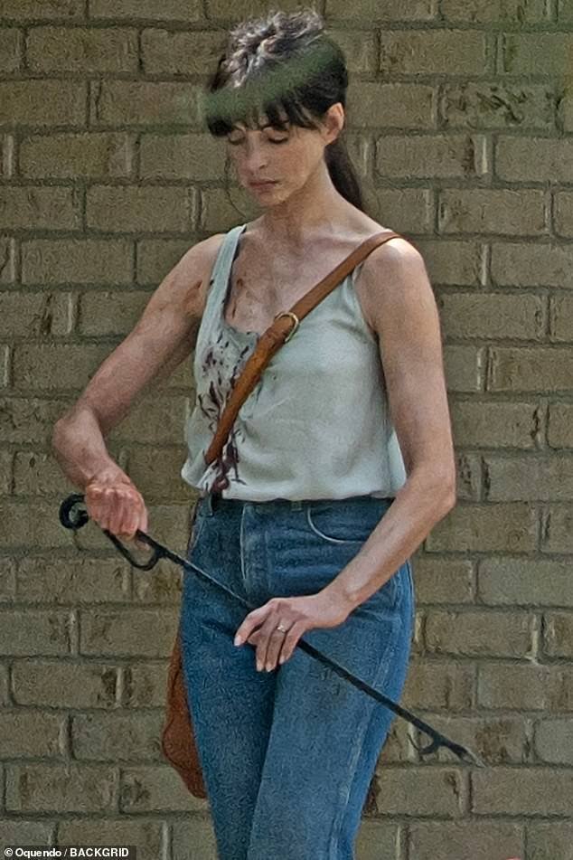 Anne Hathaway was splattered with fake blood and smeared with dirt while shooting a scene for her sci-fi film Flowervale Street in Atlanta this week
