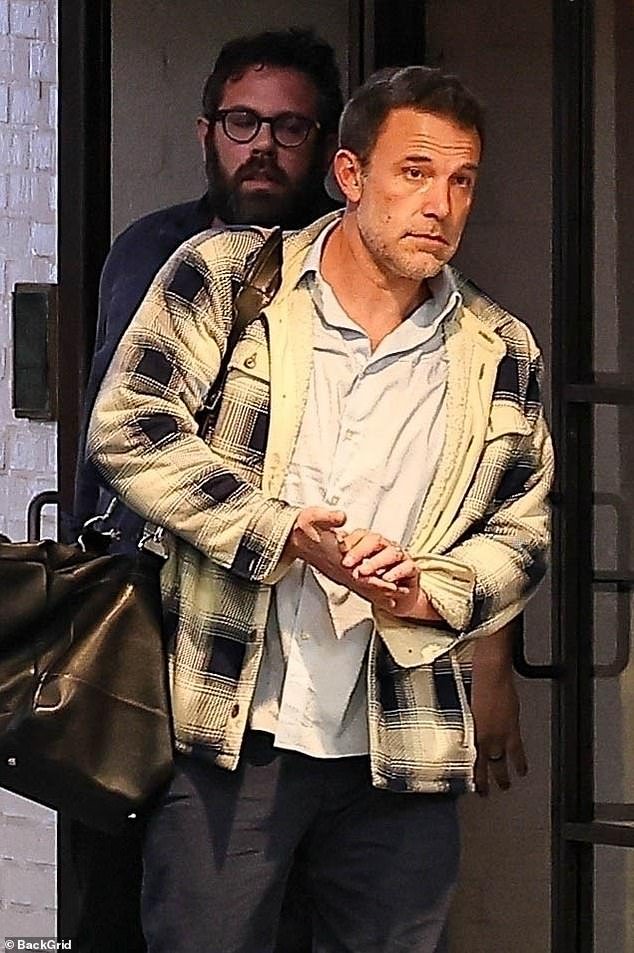 The 51-year-old actor kept it casual-cool in the fashion department in black pants with a light blue shirt, a checked jacket and white sneakers