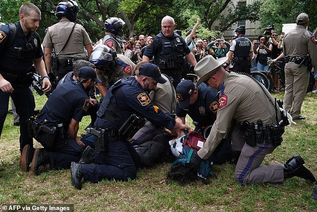 A person is detained by police as pro-Palestinian students protest the war between Israel and Hamas on the campus of the University of Texas in Austin, Texas
