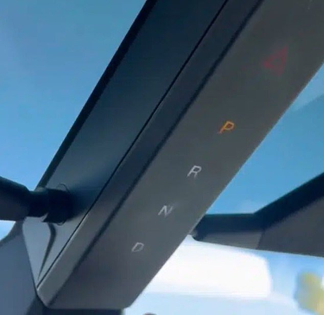 The unusual gear lever is located on a piece of trim that runs down the center of the windshield.  The sun visors are attached to the sides with magnets.  A former Tesla engineer told DailyMail.com that this poor design puts too much stress on the gear lever, which is not anchored firmly enough to handle it.
