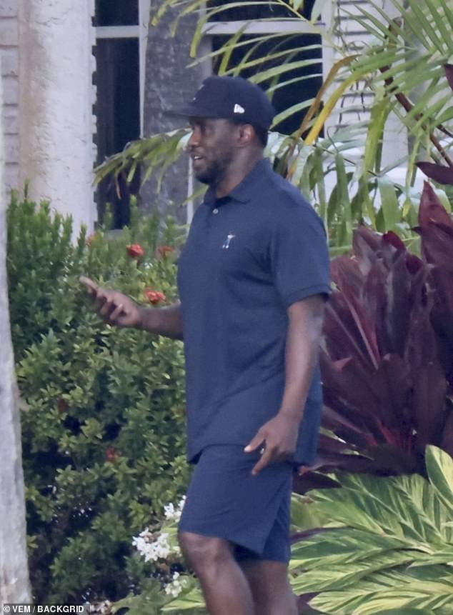 Diddy was photographed making a phone call as he walked out of his Star Island mansion in Miami