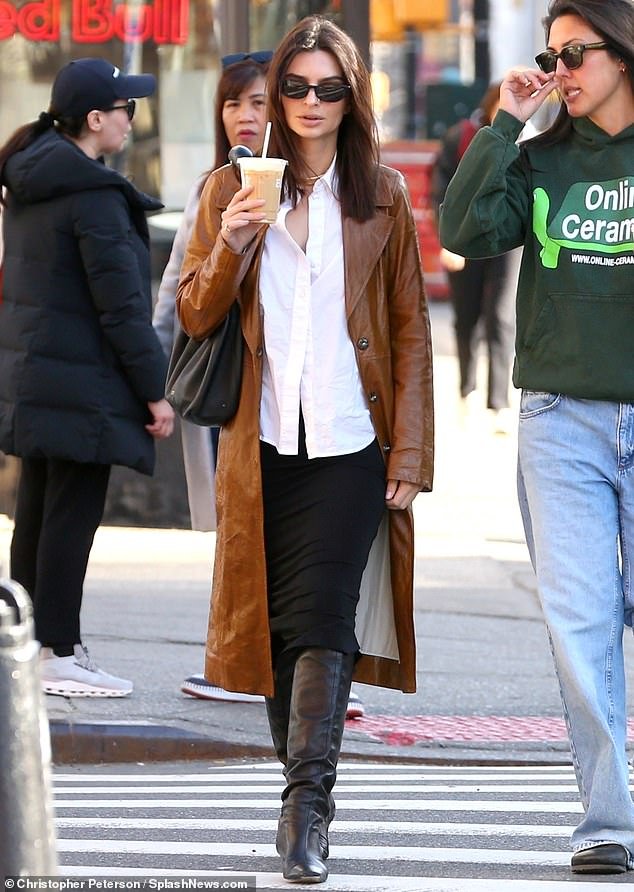 The actress and model showed off her trendy sense of style in a long leather brown trench coat as she walked through Manhattan