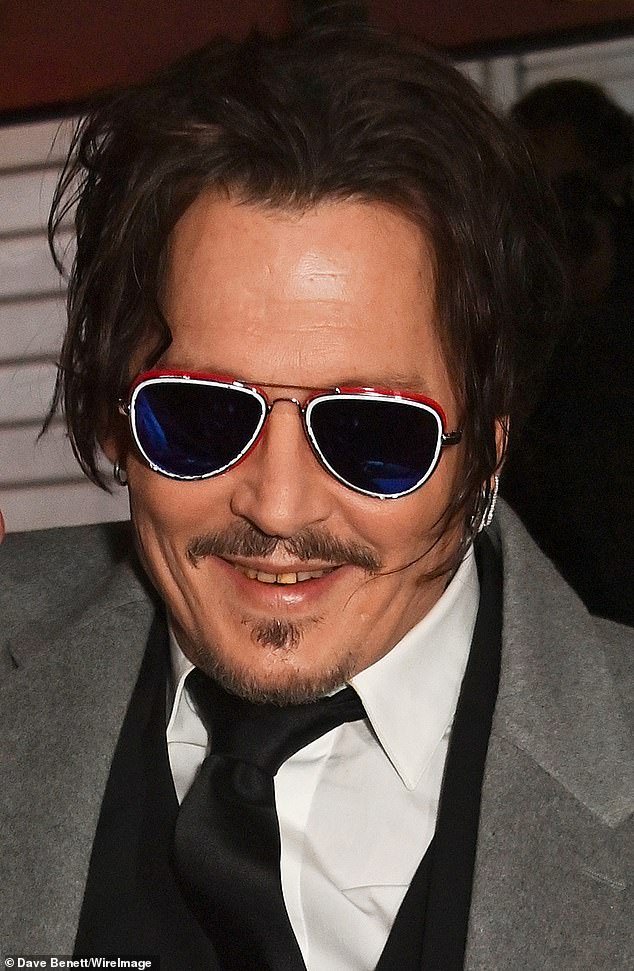 Johnny Depp bared his yellow teeth at the British premiere of his period drama Jeanne Du Barry in London on Monday