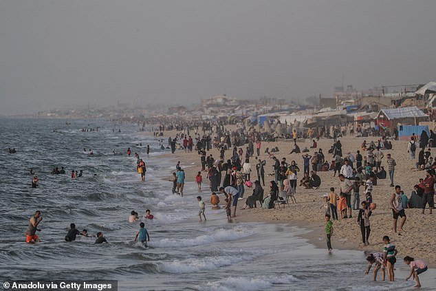 War-weary Palestinians flock to beaches and swim to catch their breath amid continued Israeli attacks in Rafah
