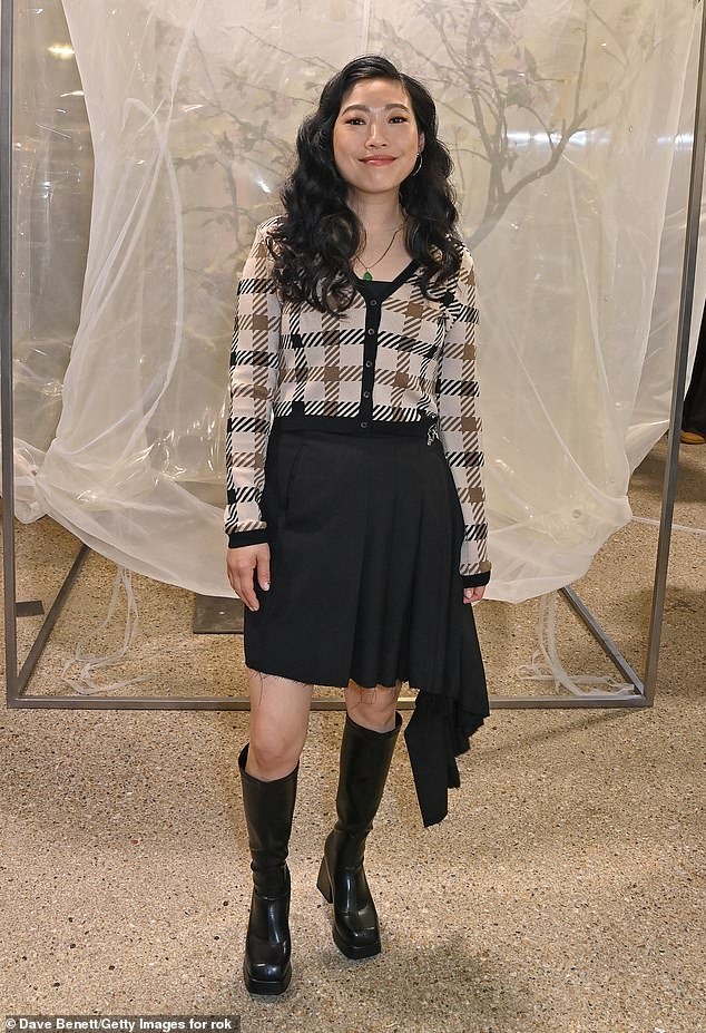 Crazy Rich Asian star Awkwafina, 35, wore a plaid sweater and pleated black skirt with knee-high patent boots
