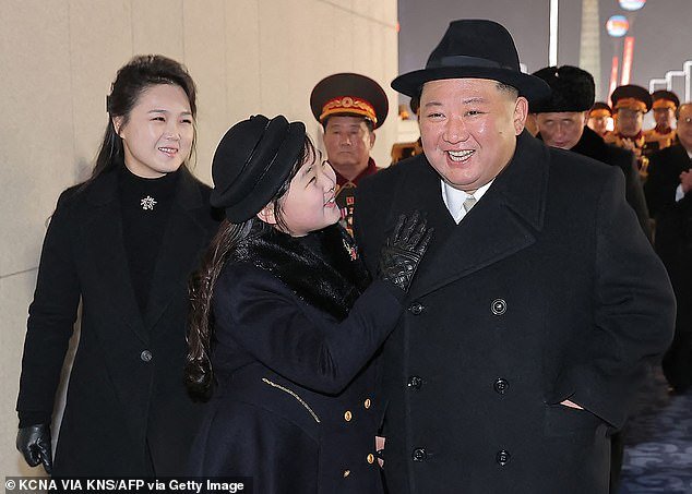 This photo, taken on February 8, 2023 and released by North Korea's official Korean Central News Agency (KCNA), shows North Korean leader Kim Jong Un (right), his daughter Ju Ae (center) and wife Ri Sol Ju (left) attending an army parade celebrating the 75th anniversary of the founding of the Korean People's Army
