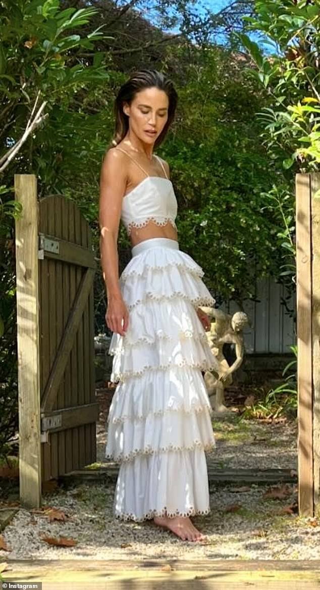 The Neighbors star, 39, shared images of herself 'looking for Easter eggs' on Sunday in an ethereal white ensemble from Sydney label IXIAH
