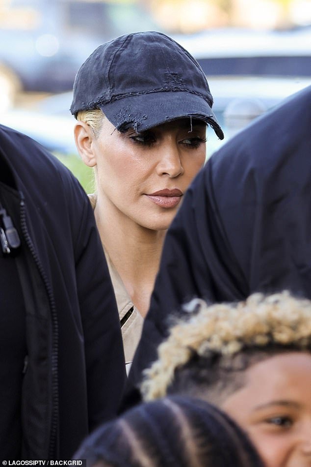 Kim Kardashian, 43, kept a low profile as she stepped out with new bleached locks as she cheered on her son Saint at his basketball game in LA on Friday