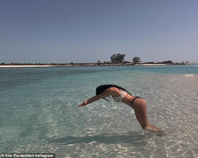 Kim Kardashian posted a photo gallery to Instagram on Wednesday from her Turks and Caicos Islands vacation, including one of her inexplicably diving into knee-deep water