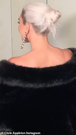 Dressed in a lush black fur coat, the 43-year-old reality star twisted from side to side to show off the hairstyle for the camera