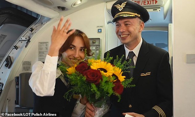 Captain Konrad Hanc (pictured, right) moved passengers and crew to tears as he introduced himself over the plane's intercom system before getting down on one knee and popping the question