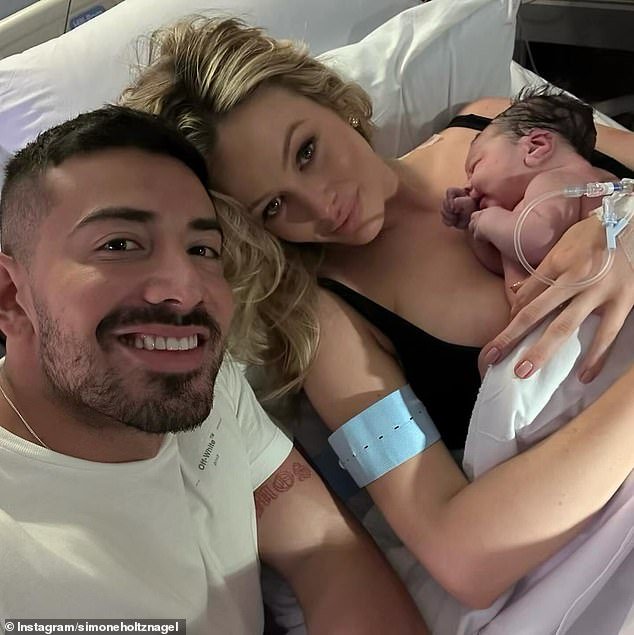 In a sweet photo, Simone held her newborn daughter as she lay in a hospital bed while Jono sat next to her.