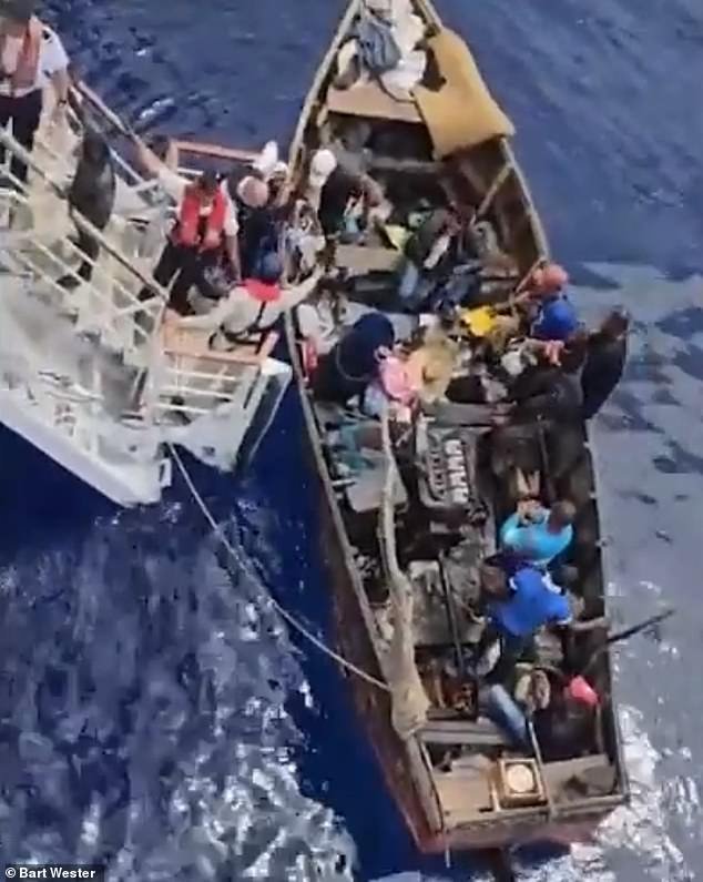Footage captured the moment more than 20 Cuban migrants were rescued from a makeshift wooden vessel about 20 miles off the coast of Cuba on Sunday