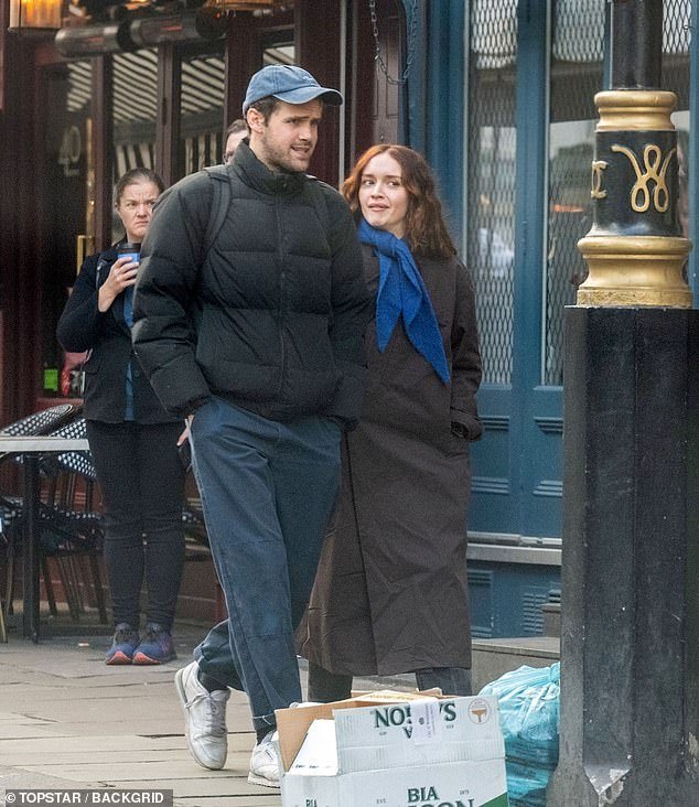 Olivia Cooke, 30, had an animated conversation with fellow actor Ralph Davis as they stepped outside for a brisk walk on Friday