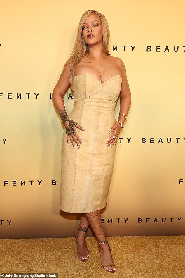 Rihanna, 36, put on a busty show in a sand-colored sheath dress at a launch event for her Fenty Beauty brand in LA on Friday