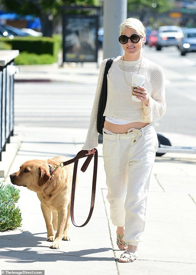 Selma Blair was spotted walking with her service dog Scout in Los Angeles on Monday.  For her outing, the actress, 51, looked effortlessly stylish in a cropped, cream-colored knit sweater with wide sleeves, layered over a white camisole.