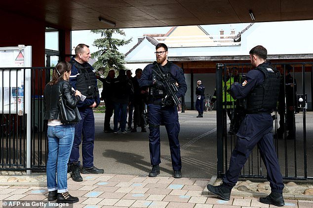A 14-year-old girl died of a heart attack in eastern France after her school (pictured on Thursday) went into lockdown to protect herself from a knife attacker who slightly injured two other girls, an official said on Friday - as pupils were left terrified by the noise of slamming doors