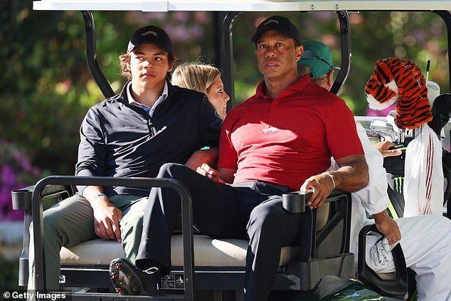 Tiger and son Charlie Woods leave the training ground in a cart during the final round