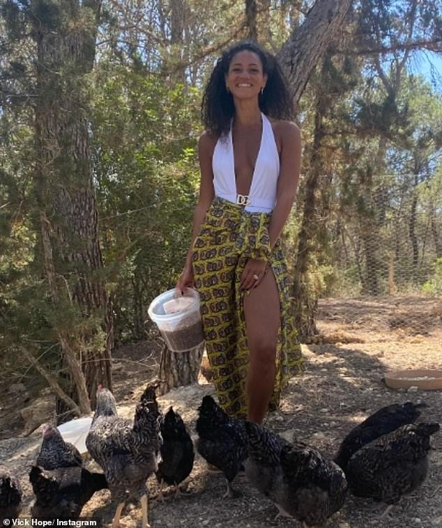Vick Hope, 34, wowed in a plunging white swimsuit as she posed for sexy Instagram photos at a chicken farm on Monday