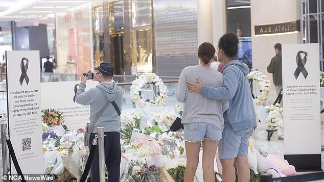 Tributes pour in as shoppers return to Westfield shopping center in Bondi Junction a week after the stabbing