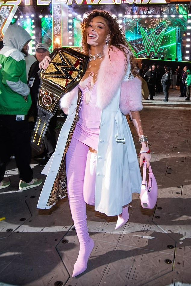 The supermodel stunned in a skimpy pink ensemble as she gushed about the 51-year-old WWE star and A-list film actor's 'iconic' return after 11 years