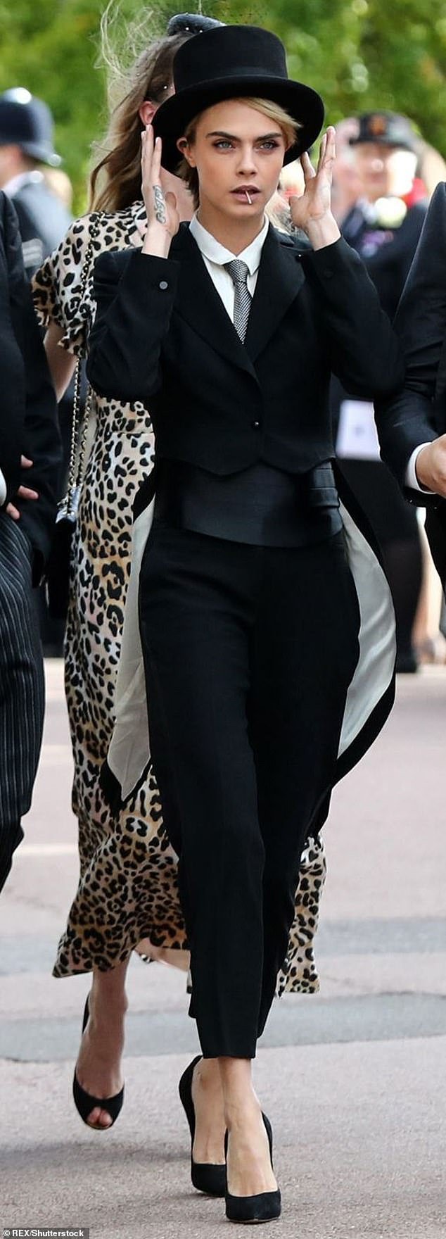 Cara Delevingne, invited to Princess Eugenie's wedding in 2018, put the royal bride on full display by wearing a top hat and tails