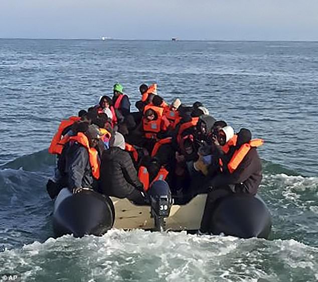 The massively overcrowded small boat with 112 people on board briefly ran aground off the northern French coast at Wimereux, near Boulogne-sur-Mer.  Migrants are seen boarding the boat for the second time, en route to a successful crossing, after the tragedy occurred earlier in the day