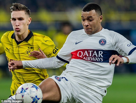 DORTMUND, GERMANY – DECEMBER 13: Kylian Mbappe of Paris Saint-Germain is challenged by Nico Schlotterbeck of Borussia Dortmund during the UEFA Champions League match between Borussia Dortmund and Paris Saint-Germain at Signal Iduna Park on December 13, 2023 in Dortmund, Germany.  (Photo by Boris Streubel/Getty Images)