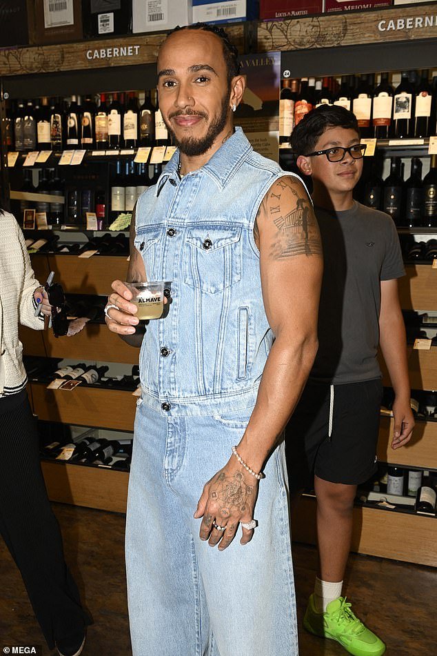 The F1 driver, 39, opted for a typically quirky look for the outing as he wore a sleeveless denim top with matching loose-fitting jeans.