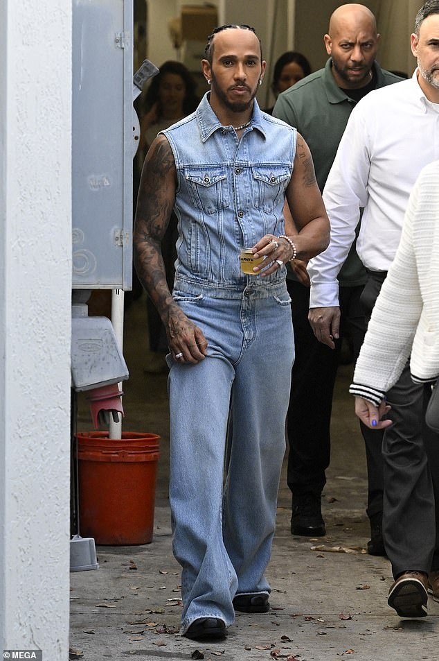 Lewis showed off his arm tattoos and also wore a pair of black shoes as he mingled with his guests